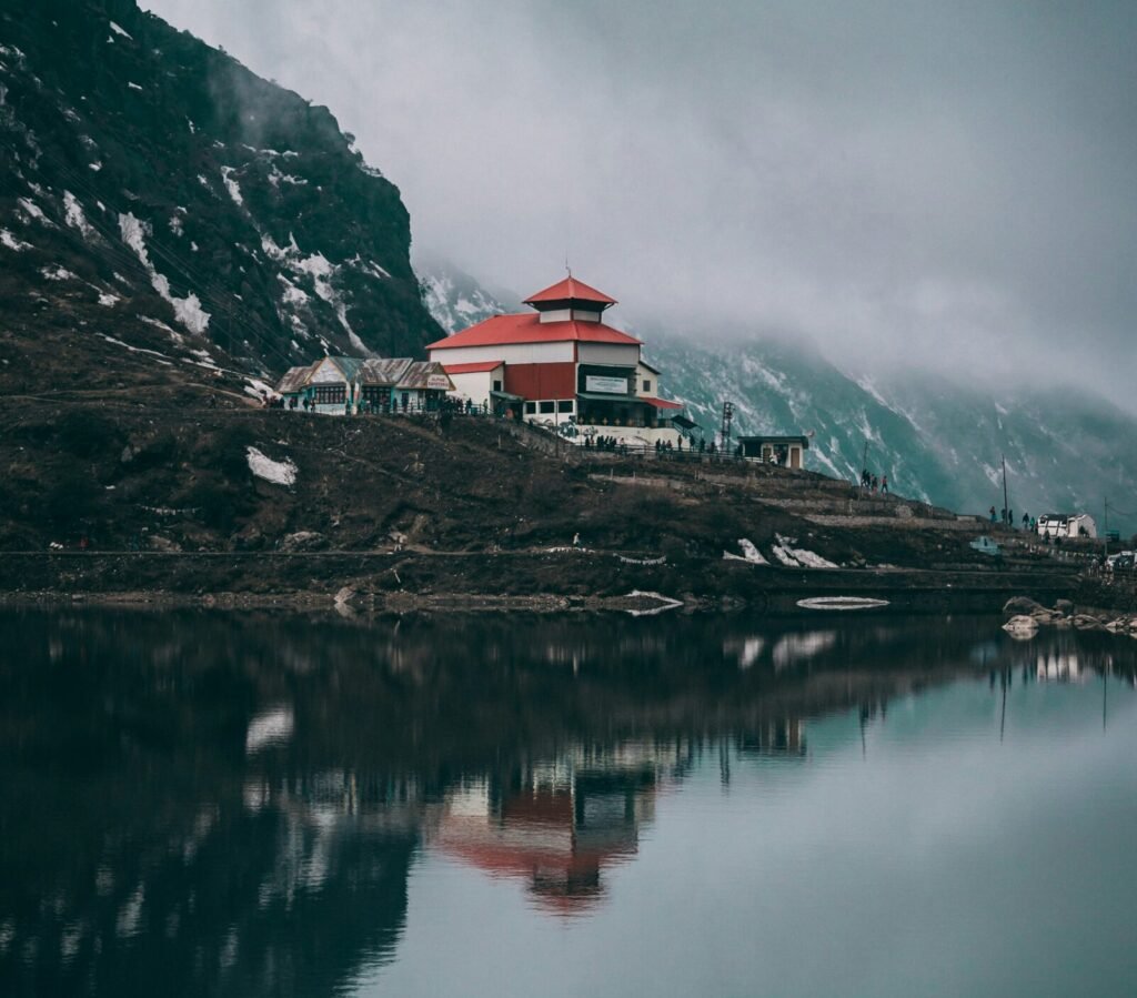 white and red concrete building near body of water